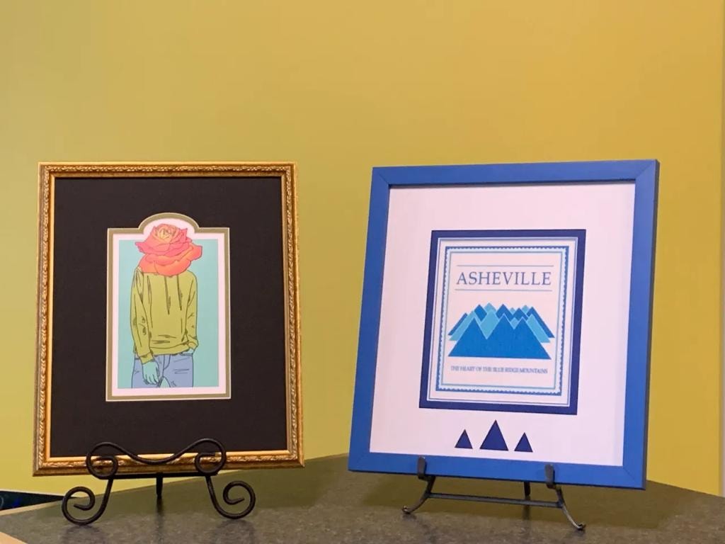 Framed artwork on easels yellow background